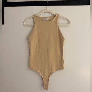 Nude high-neck sleeveless bodysuit